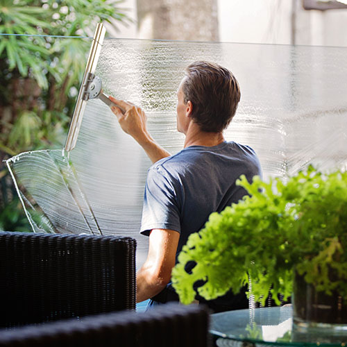 person cleaning window