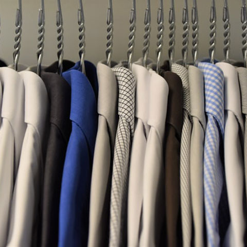 close up on clean shirts in a closet