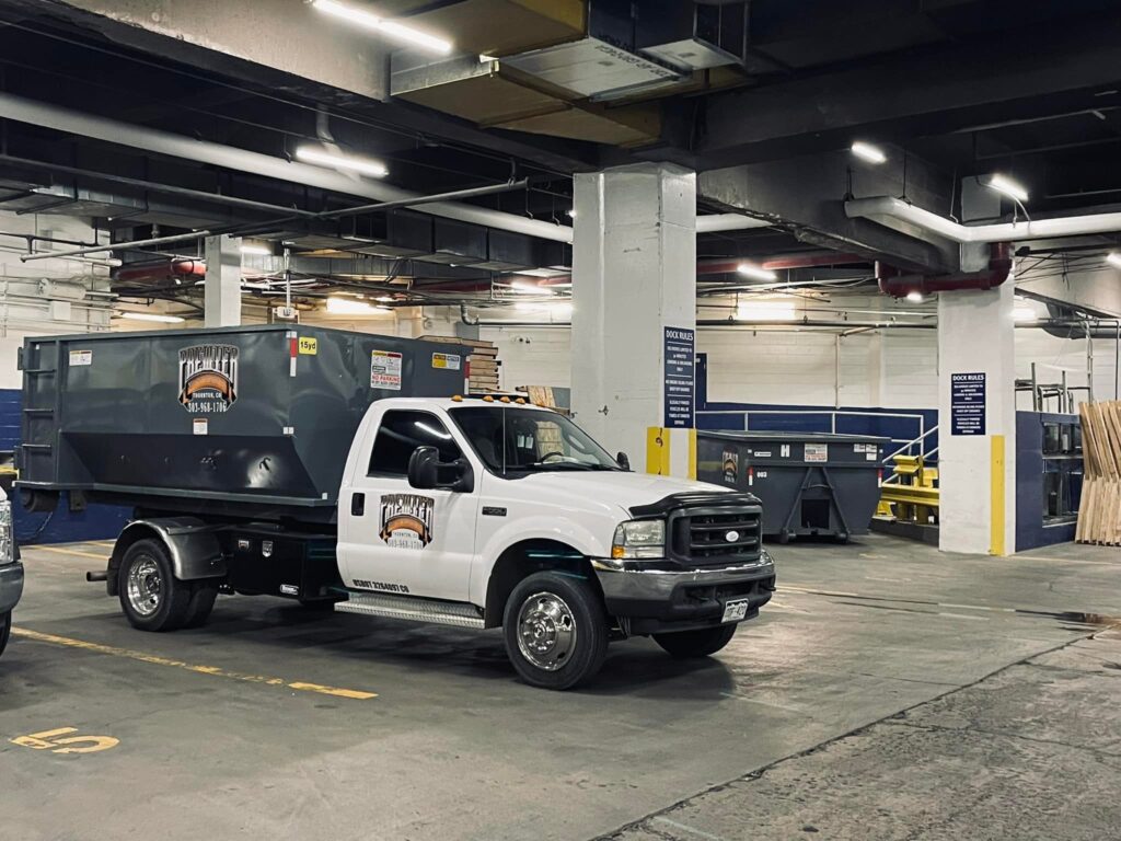 Professional dumpster rental Westminster CO being parked in a parking garage before delivery.