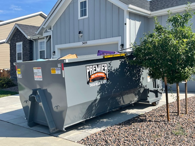 A dumpster Rental being dropped off at a home in Brighton CO.