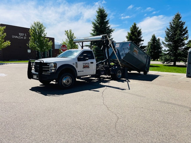 a dumpster attached to a vehicle. 