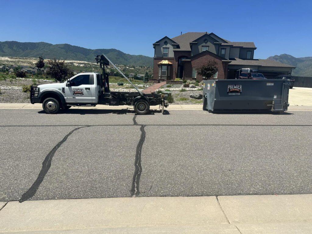 40 Yard Dumpster Rental in Centennial, CO placed beside a home remodel as workers load torn-out materials